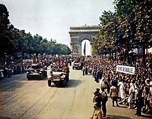 French patriots line the Champs-Élysées on 26 August 1944, the day after the liberation of Paris, as Free French troops from General Leclerc's 2nd Armoured Division pass the Arc du Triomphe