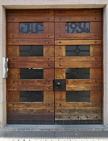 Entrance door in Bolzano (Grieser Platz) from 1934 with elements of wood, glass and iron