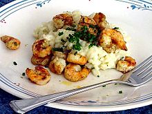 Grilled shrimps on risotto with lemon and chives