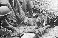 I marines statunitensi trascinano i corpi dei soldati giapponesi morti dal loro bunker nella zona di Point Cruz dopo la battaglia all'inizio di novembre.