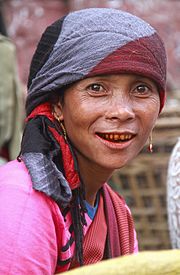 Street vendor of paan: finely chopped betel nuts and spices wrapped with leaves of betel pepper ­and coated with slaked lime; legal ­selling and daily chewing of the mildly narcotic stimulant drug ­is widespread in India­, it reddens gums ­and blackens teeth (Shillong, Meghalaya, 2014)