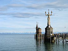 The Imperia at the harbour entrance at Lake Constance, in the background the Alps
