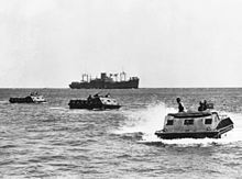 Amphibious landing units on their way to Guadalcanal beach. The ship in the background is the President Hayes.