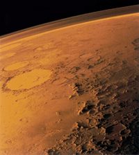 Above the Martian horizon the atmosphere is visible as a hazy veil.