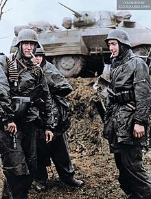 Members of Kampfgruppe Hansen (LSSAH) after an attack in which the U.S. 14th Cavalry group was completely routed on the road between Poteau and Recht in Belgium on December 18, 1944 (colored).