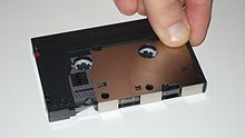 Digital Compact Cassette with open protective cover