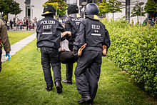 Berlin police officers during the arrest of a demonstrator