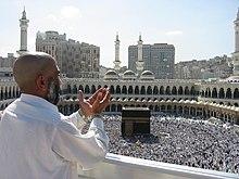 Pilgrims at the prayer of supplication in Mecca, in the middle ground the Kaaba