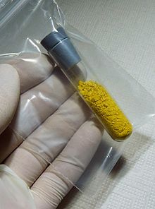 crumbly yellowcake in test tube